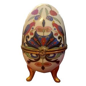 Vintage porcelain egg with bird pattern.